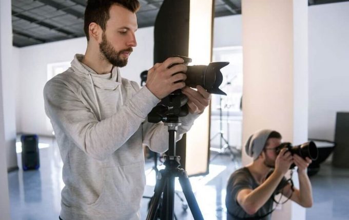 Two photographers collaborating in a well-equipped studio environment