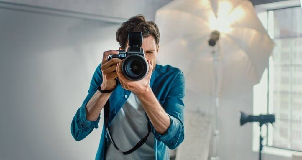 Skilled photographer engrossed in creative work within a professional studio setting